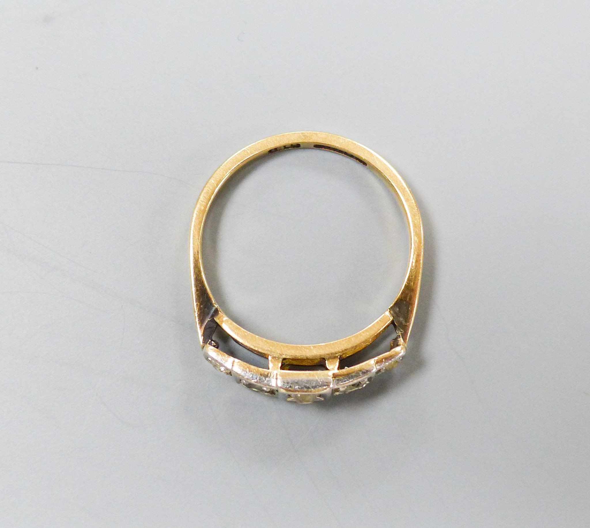 An 18ct & platinum, graduated five stone diamond set half hoop ring, size N, gross 3.2 grams.